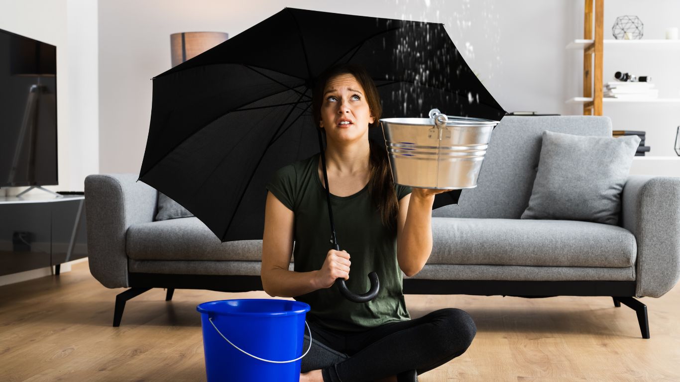Woman using umbrella inside the house