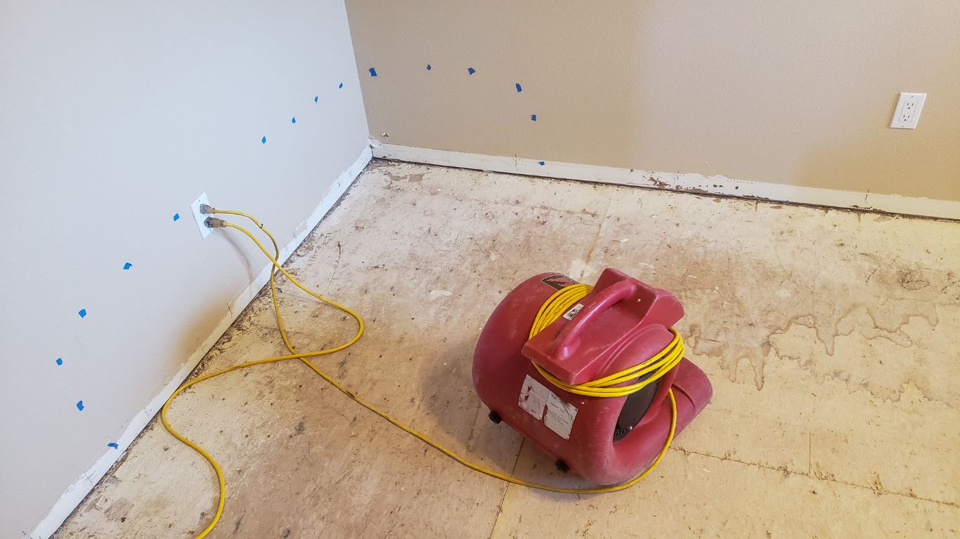 Water damage in home with air blower for water damage restoration services in Denver.