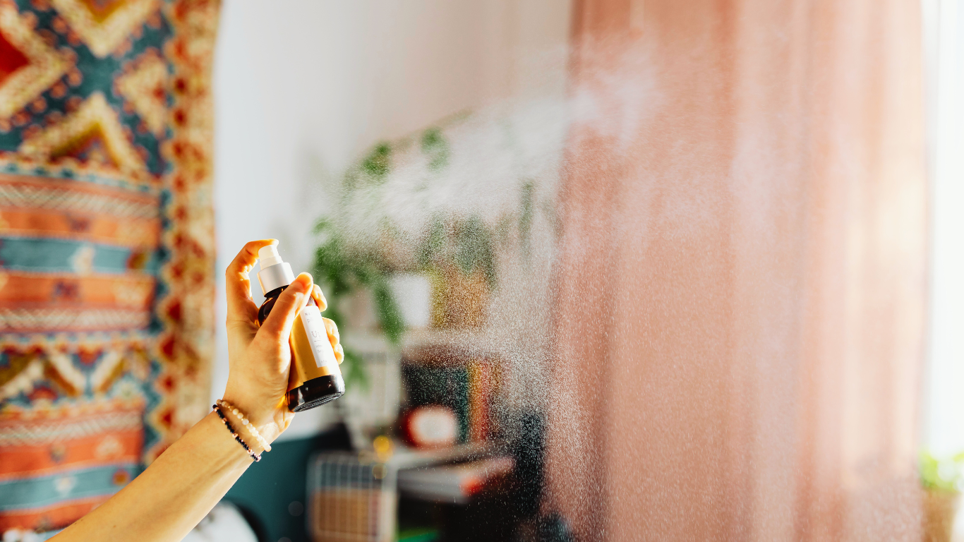 Why DIY Air Fresheners Aren’t Enough for Serious Odor Problems A person sprays air freshener in a cozy room, illustrating how DIY solutions often fall short for resolving serious odor problems.
