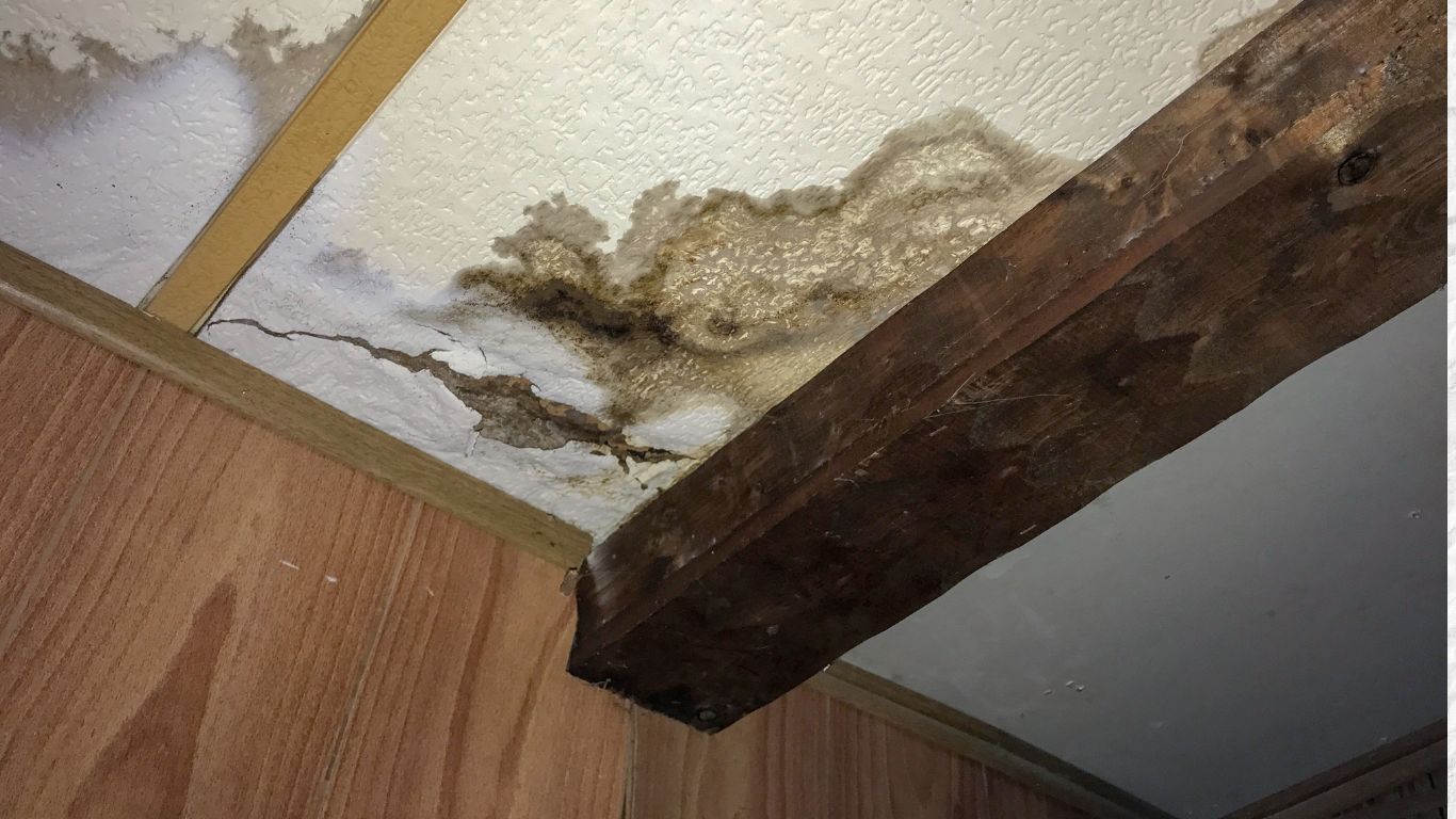 Ceiling with water damage, stains, and cracks, showing the need for water damage restoration in Minneapolis.